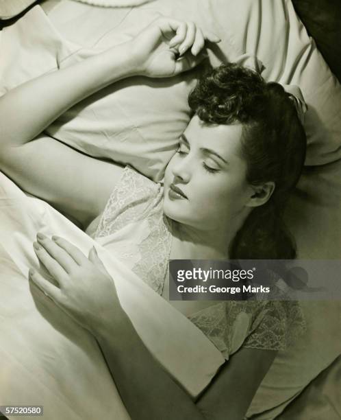 young woman asleep on bed, (b&w), close-up - 1940s bedroom stock pictures, royalty-free photos & images