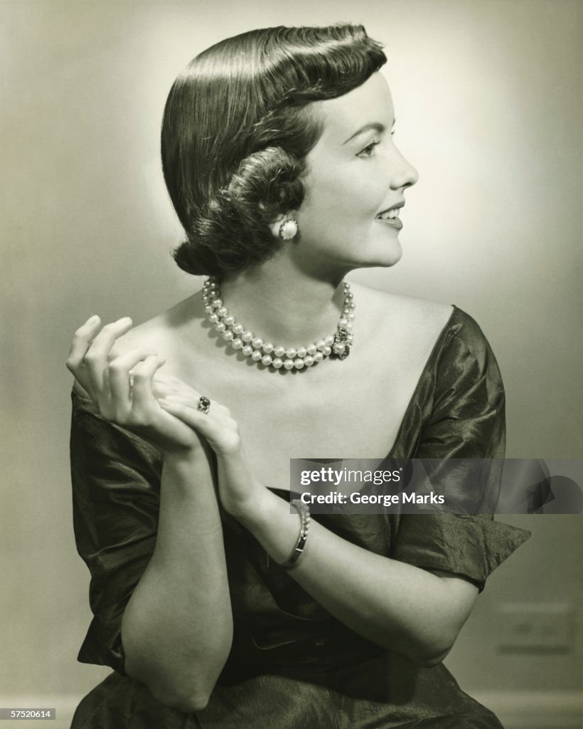 Elegant woman posing in studio, (B&W)