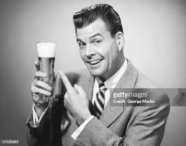 businessman in full suit in studio pointing at glass of beer, (b&w), portrait - advertisement stock pictures, royalty-free photos & images