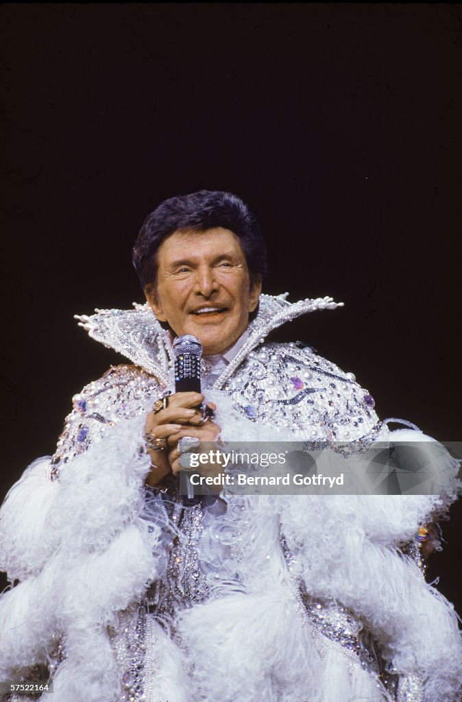 Liberace Ruffle Flamboyant American piano player and entertainer Liberace sings into ...