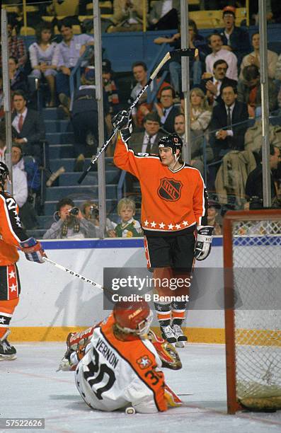 Mario Lemieux of the Wales Conference and the Pittsburgh Penguins celebrates a goal against goalie Mike Vernon of the Campbell Conference and the...