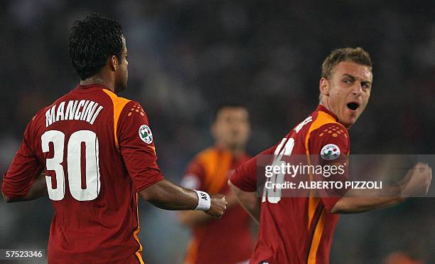 Roma midfielder Brazilian Mancini Alessandro Amantino celebrates after scoring against Inter Milan's flanked by his teammate midfielder Daniele de...