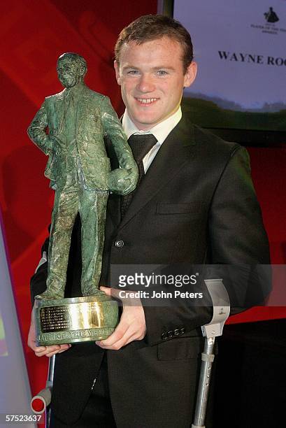 Wayne Rooney of Manchester United poses with the Sir Matt Busby Player of the Year Award, voted by Manchester United fans as their favorite player,...