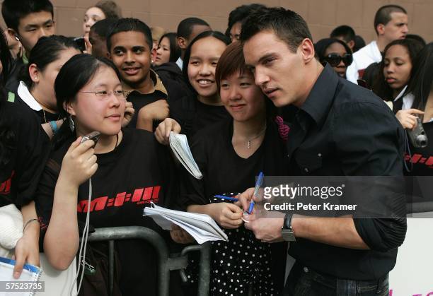Actor Jonathan Rhys Meyers poses for photos with fans at the premiere of "Mission: Impossible III" at Tribeca Performing Arts Center during the 5th...