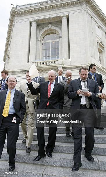 United States Treasury Secretary John Snow walks down the steps of the Cannon House Office Building after a news conference to introduce the Tax-Free...