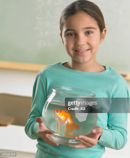 young girl holding a fishbowl - goldfish bowl stock pictures, royalty-free photos & images