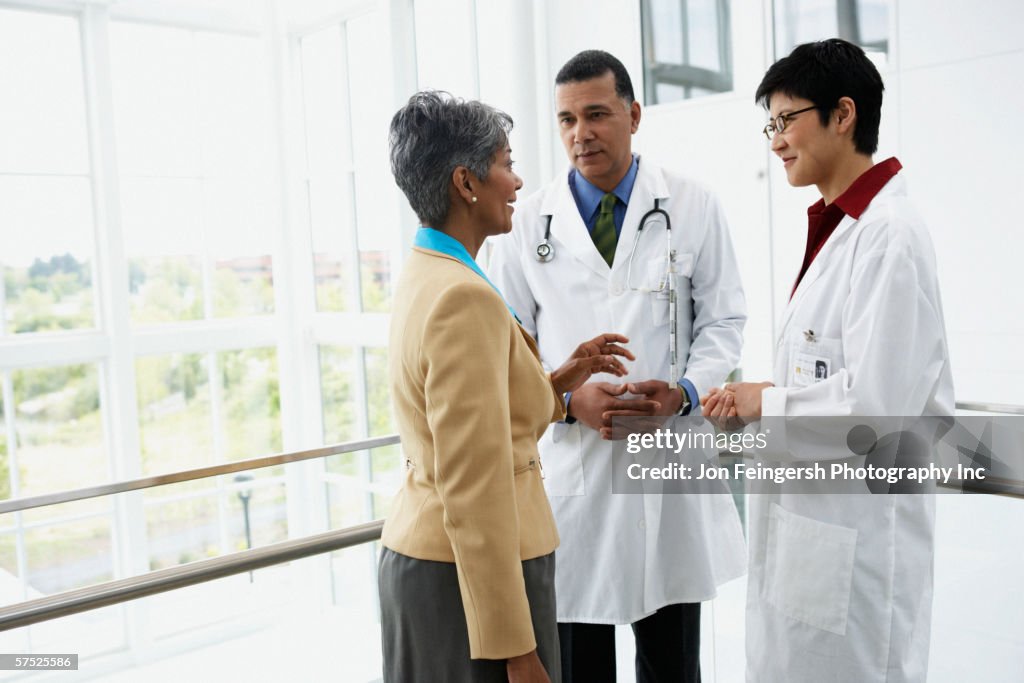 Doctors talking to businesswoman