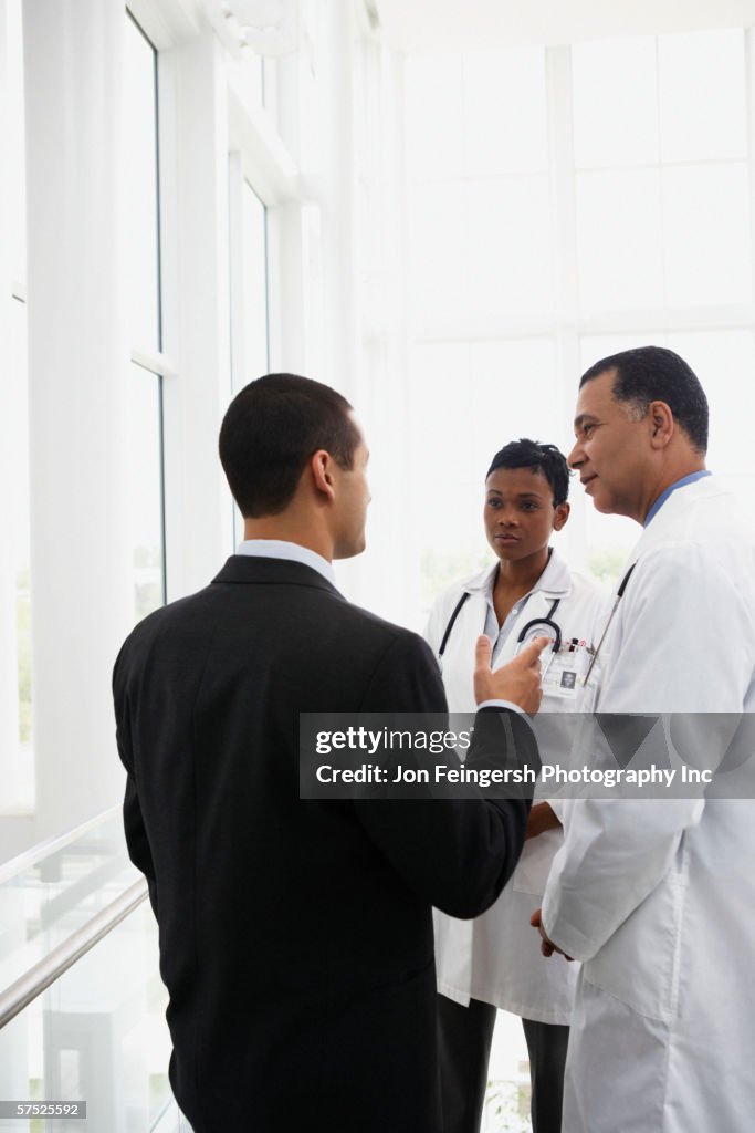 Doctors talking to businessman