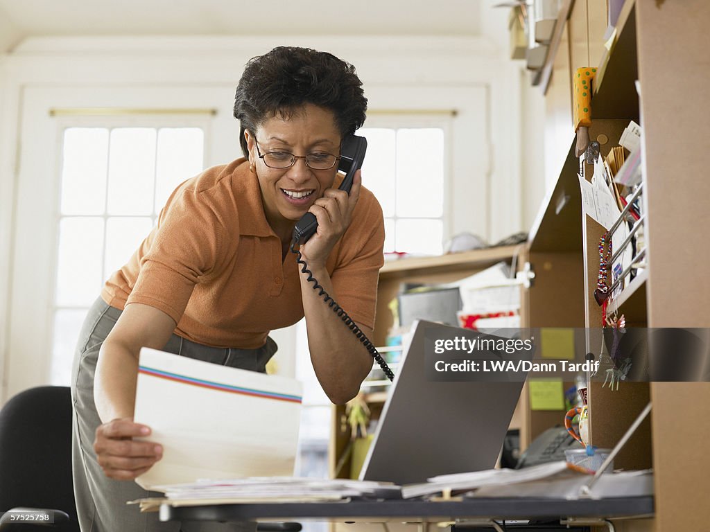 Businesswoman talking on the phone at her desk