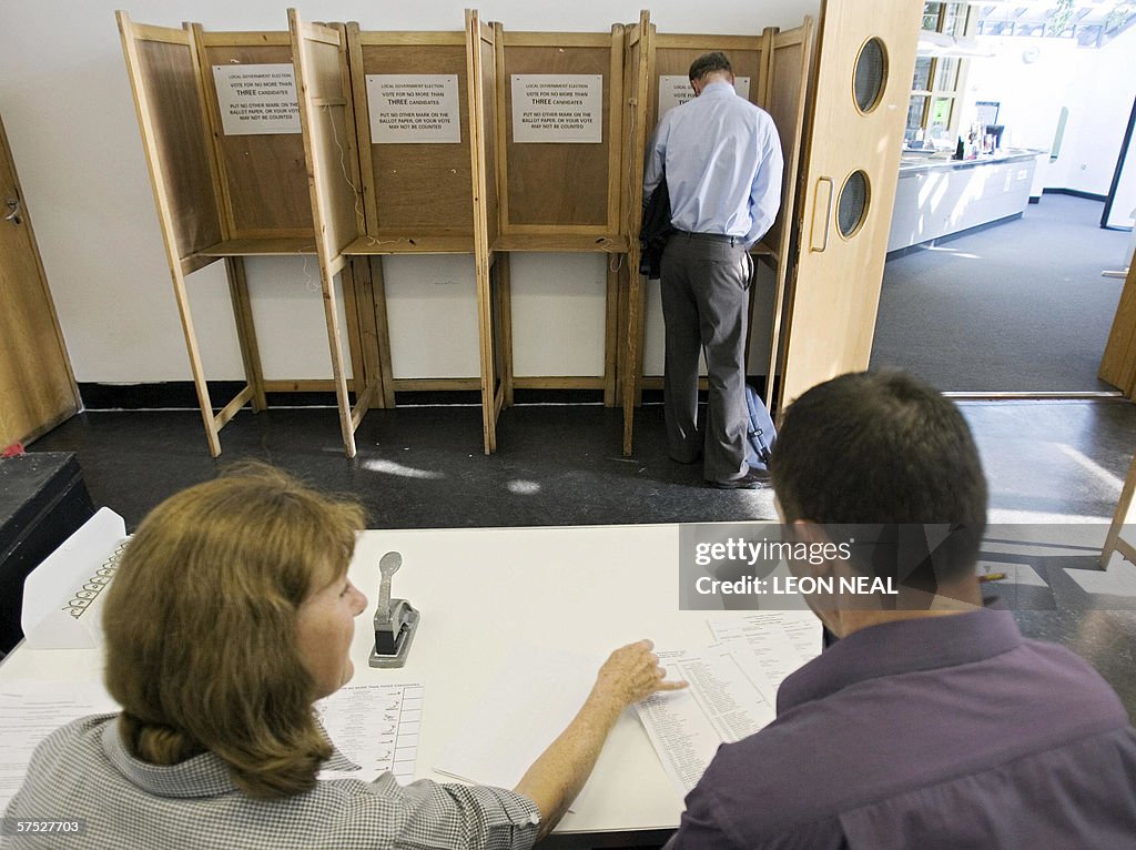 A voter marks his voting card in a polli