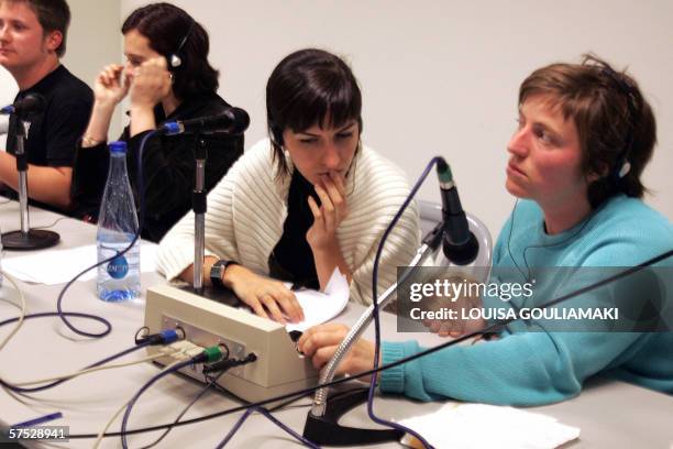 Babels' network English interpreter breast-feeds her baby at the start of a seminar on the first day of the European Social Forum in Athens, 04 May...