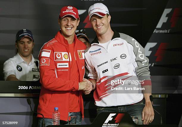Michael Schumacher of Germany and Ferrari shakes hands with his brother Ralf Schumacher of Germany and Toyoto during the previews for the European F1...