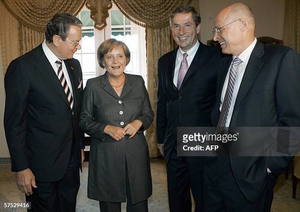 New York, UNITED STATES: German Chancellor Angela Merkel meets with Jurgen R. Thurman, President of the Federation of German Industries, Klaus...
