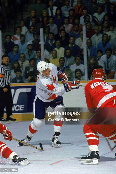 Canadian professional hockey player Mario Lemieux , center for the Pittsburgh Penguins and member of Team Canada, fires a shot as Russian hockey...