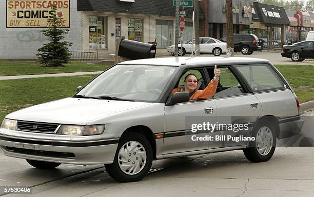 Customer Deb Kuhn of Oak Park, Michigan gives a thumbs up as she finally enters the gas station after having waited almost two hours in a three-mile...