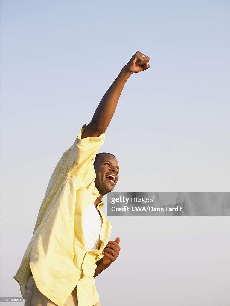 Young man punching the air in triumph