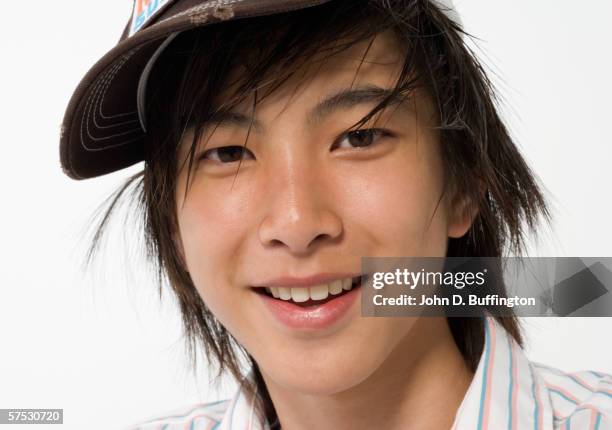 teenage boy smiling for the camera - teenage boy in cap posing stock pictures, royalty-free photos & images