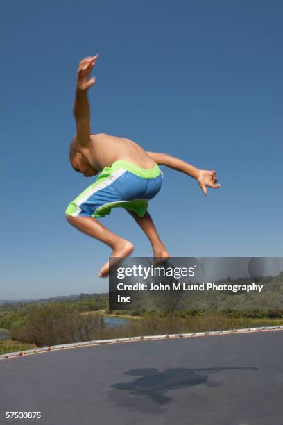 Young Boy Jumping On A Trampoline High-Res Stock Photo