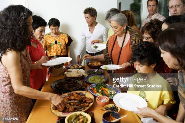 people eating at a buffet - native american family stock pictures, royalty-free photos & images
