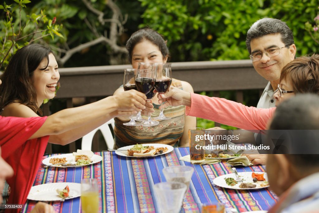 People toasting each other at the dinner table