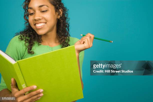 young woman writing in a book - hill street studios bildbanksfoton och bilder