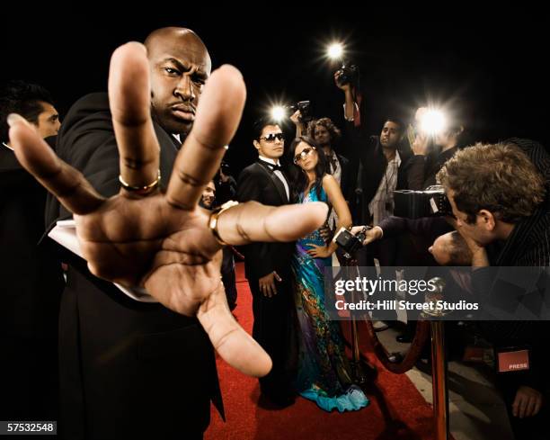 bouncer preventing entrance to a celebrity event - bodyguard fotografías e imágenes de stock