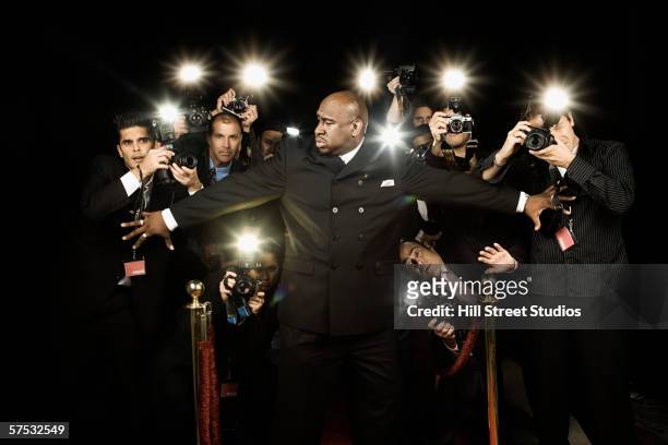 bouncer holding photographers back - only mid adult men stock pictures, royalty-free photos & images