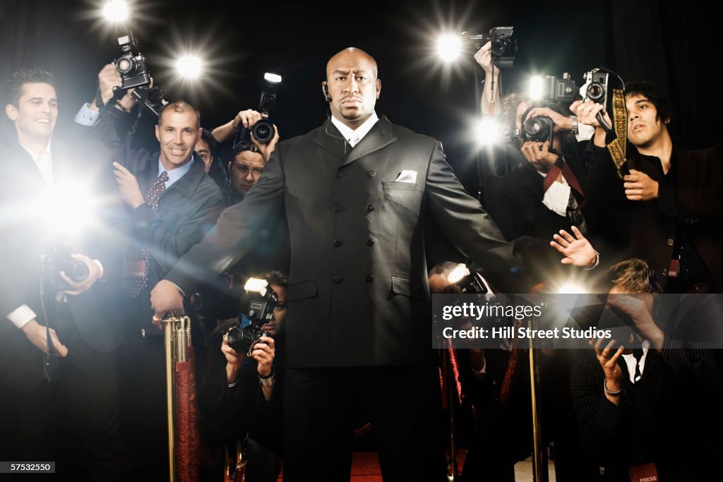 Bouncer holding photographers back