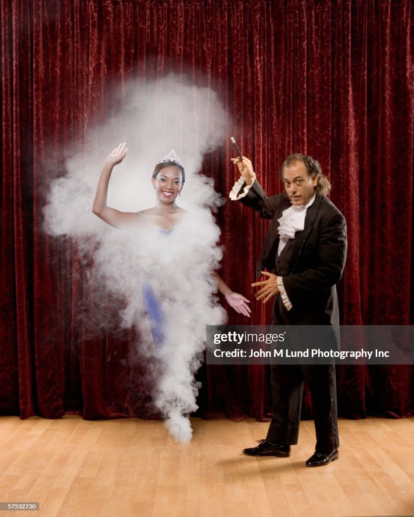 Magician making woman appear out of thin air