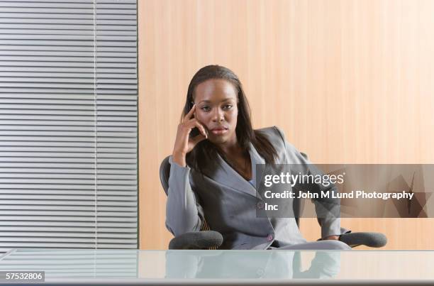 businesswoman sitting behind an empty desk - one empty desk stock pictures, royalty-free photos & images