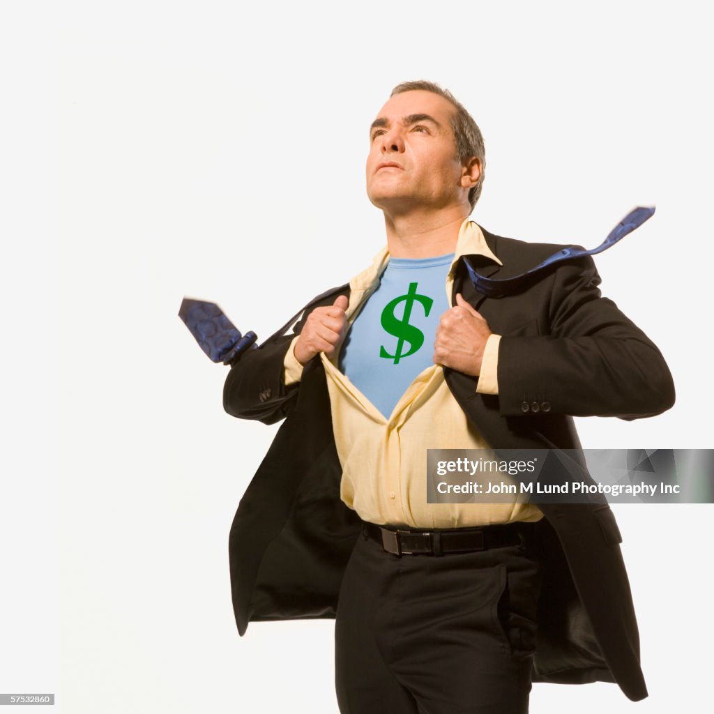 Businessman pulling back his shirt to reveal a dollar-sign superhero outfit
