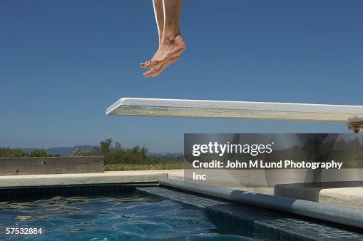 Person jumping on the diving board Person jumping on the diving board