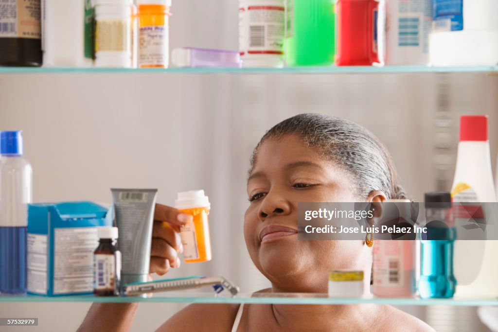 Woman examining pill bottle