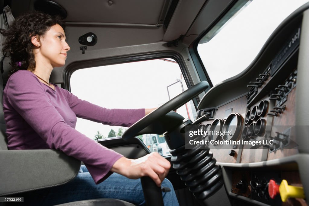 Young woman driving her truck
