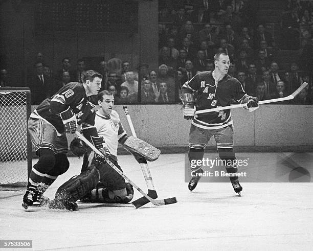 Canadian professional hockey player Roger Crozier , goalie for the Detroit Red Wings, attempts to defend the goal during a game with the New York...