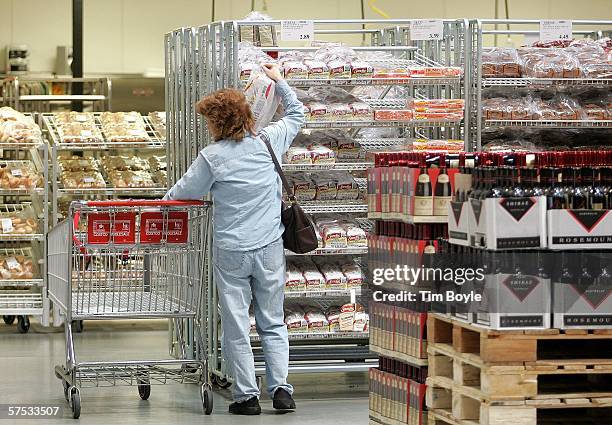 Woman reaches for some bread as she shops at the Costco store May 4, 2006 in Mount Prospect, Illinois. Retail spending in April was reportedly the...