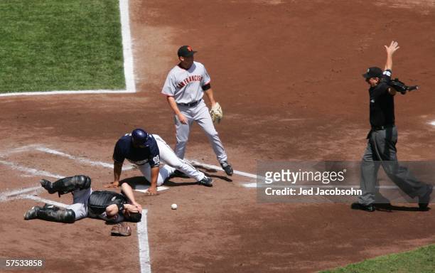 Todd Greene of the San Francisco Giants lies on the ground after Prince Fielder of the Milwaukee Brewers scored in the first inning as umpire Tim...