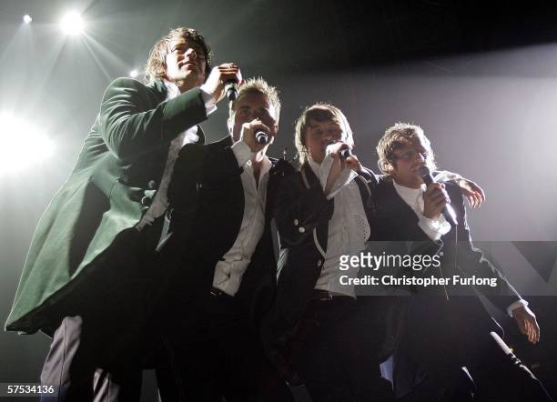 Singers Howard Donald, Gary Barlow, Mark Owen and Jason Orange of Take That perform on stage as part of the band's 'Ultimate Tour 2006' at Manchester...