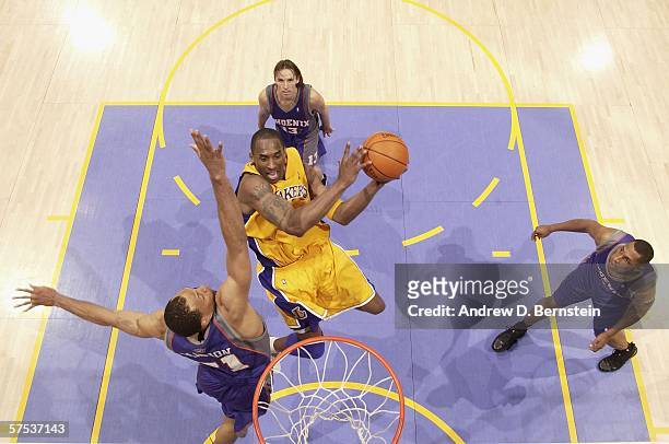 Kobe Bryant of the Los Angeles Lakers goes strong to the hoop against Shawn Marion, Steve Nash and Boris Diaw of the Phoenix Suns in game six of the...