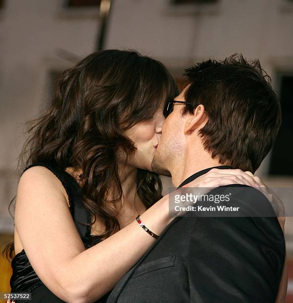 Actor Tom Cruise and actress Katie Holmes kiss as they arrive at the Paramount Pictures fan screening of "Mission: Impossible III" held at the...