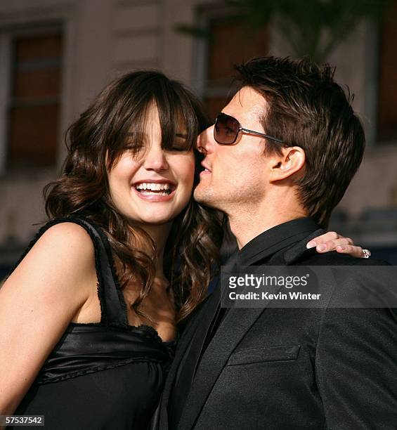 Actor Tom Cruise kisses actress Katie Holmes as they arrive at the Paramount Pictures fan screening of "Mission: Impossible III" held at the...