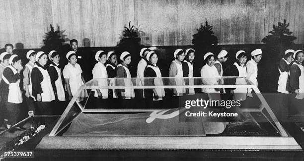 The body of Chairman Mao Tse-Tung lying in state as workers file past, in Peking, September 1976. Printed after the 1st anniversary of his death on...