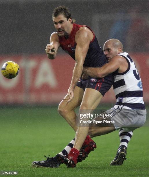 Nathan Carroll of the Demons is tackled by Paul Chapman of the Cats during the round six AFL match between the Melbourne Demons and the Geelong Cats...