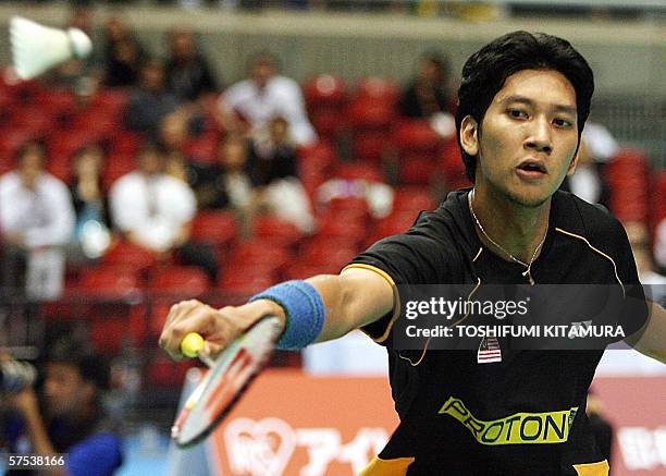 Mahat Hashim Muhd Hafiz B Hashim of Malaysia returns the shuttlecock to Kenneth ...