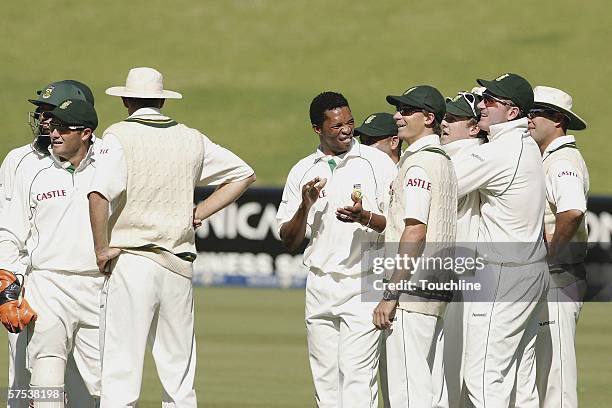 De Villiers of South Africa is congratulated by Makhaya Ntini and teammates after his catch to get Scott Styriss of New Zealand for a duck during day...