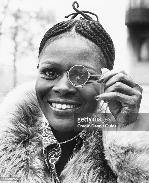Portrait of American actress Cicely Tyson holding a monocle to her eye during a visit to London, February 19th 1973.