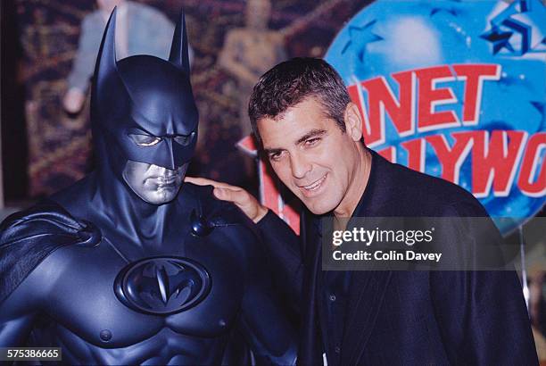 American actor George Clooney poses with a model of Batman during a photocall for his latest film 'Batman and Robin' at Planet Hollywood, London, UK,...