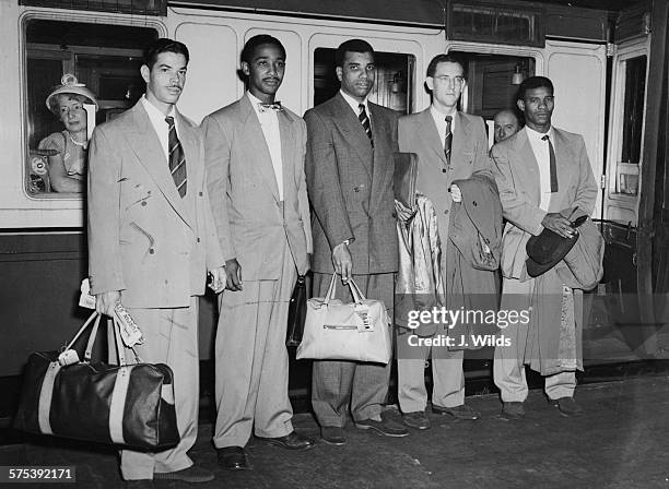 Players of the West Indian Cricket Team standing next to their train as they prepare to leave for a tour of Australia; Kenneth Rickards, Frank...