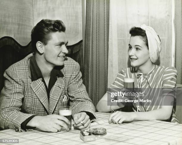 couple drinking beer at bar table, (b&w) - black and white couple stock pictures, royalty-free photos & images