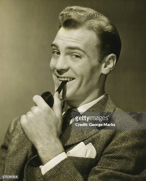 businessman holding pipe in mouth, smiling, (b&w), portrait - pipe smoking pipe stock pictures, royalty-free photos & images